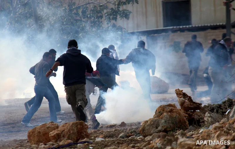 Israeli soldiers clash with Palestinian stone throwers following a protest against the closure of a road during the second Intifada (began late September 2000) by Jewish settlers from the nearby settlement of Kadumim, on...