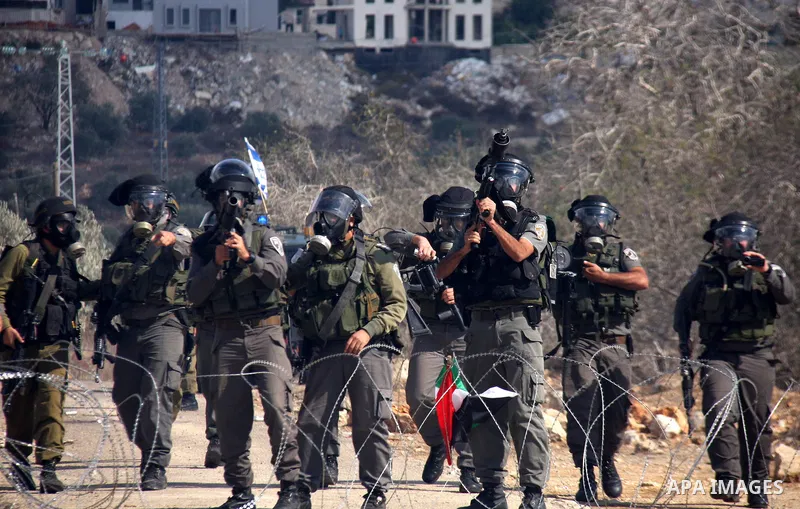 Israeli soldiers clash with Palestinian stone throwers following a protest against the closure of a road during the second Intifada (began late September 2000) by Jewish settlers from the nearby settlement of Kadumim, on...
