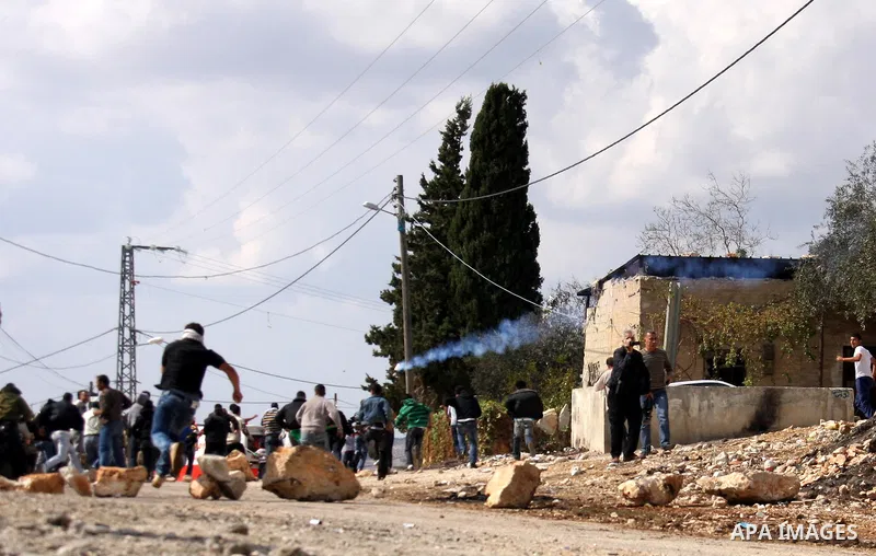 Israeli soldiers clash with Palestinian stone throwers following a protest against the closure of a road during the second Intifada (began late September 2000) by Jewish settlers from the nearby settlement of Kadumim, on...