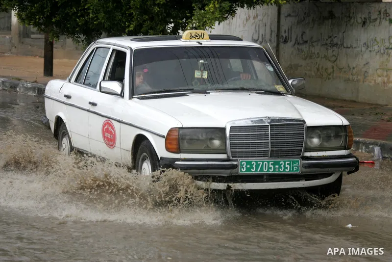 Palestinians cross through the rain water in a street in the Rafah refugee camp southern Gaza Strip on Nov. 4, 2011. Photo by Abed Rahim Khatib