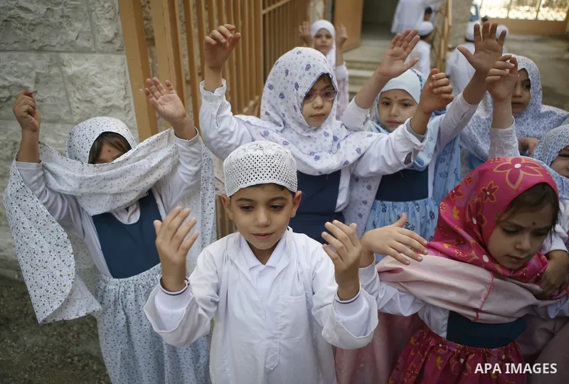 Palestinian children perform a simulated pilgrimage celebrating the upcoming Islamic pilgrimage and Eid al-Adha festival in the West Bank city Nablus, Thursday, Nov. 5, 2011. Palestinian Muslims will celebrate Eid al-Adh...