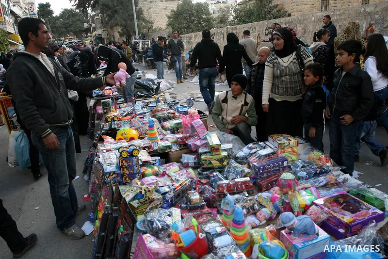 Palestinians shopping to celebrate Eid al-Adha festival in a market of Gaza City on Nov. 4, 2011. Muslims across the world are preparing to celebrate the annual festival of Eid al-Adha, or the Festival of Sacrifice. Phot...
