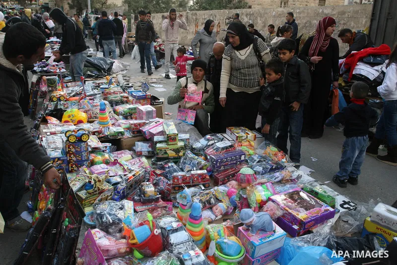 Palestinians shopping to celebrate Eid al-Adha festival in a market of Gaza City on Nov. 4, 2011. Muslims across the world are preparing to celebrate the annual festival of Eid al-Adha, or the Festival of Sacrifice. Phot...