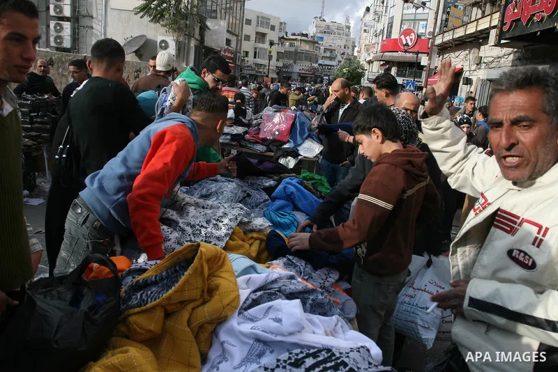 Palestinians shopping to celebrate Eid al-Adha festival in a market of Gaza City on Nov. 4, 2011. Muslims across the world are preparing to celebrate the annual festival of Eid al-Adha, or the Festival of Sacrifice. Phot...