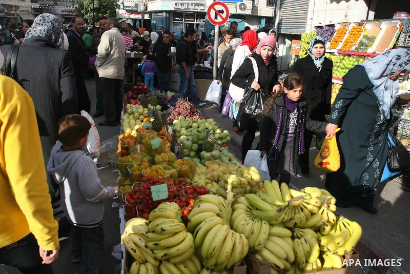 Palestinians shopping to celebrate Eid al-Adha festival in a market of Gaza City on Nov. 4, 2011. Muslims across the world are preparing to celebrate the annual festival of Eid al-Adha, or the Festival of Sacrifice. Phot...