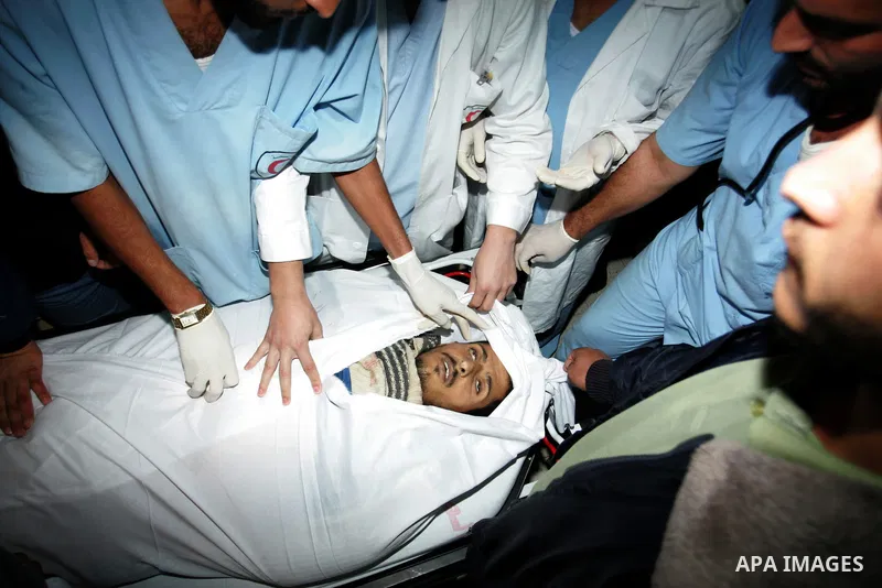 Palestinians gather as the body of Abdullah Mohana, Islamic Jihad militant, is brought to the morgue of the Nasser hospital in Khan Younis, southern Gaza Strip, Saturday, Nov. 5, 2011. A Palestinian official said that on...