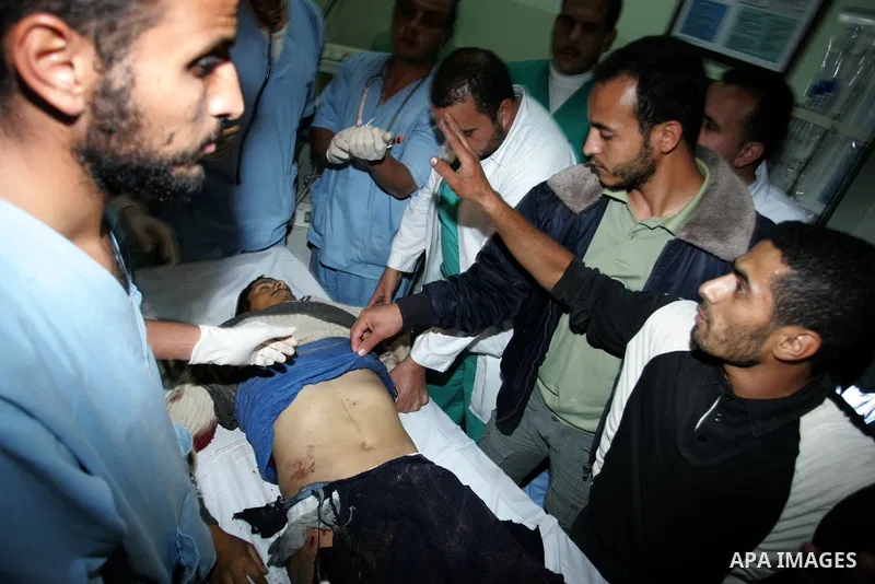 Palestinians gather as the body of Abdullah Mohana, Islamic Jihad militant, is brought to the morgue of the Nasser hospital in Khan Younis, southern Gaza Strip, Saturday, Nov. 5, 2011. A Palestinian official said that on...