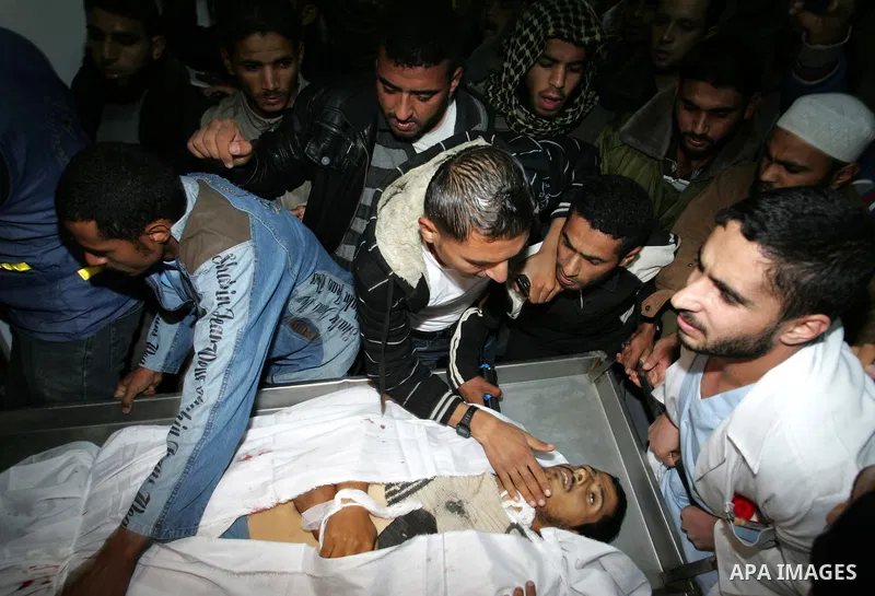 Palestinians gather as the body of Abdullah Mohana, Islamic Jihad militant, is brought to the morgue of the Nasser hospital in Khan Younis, southern Gaza Strip, Saturday, Nov. 5, 2011. A Palestinian official said that on...