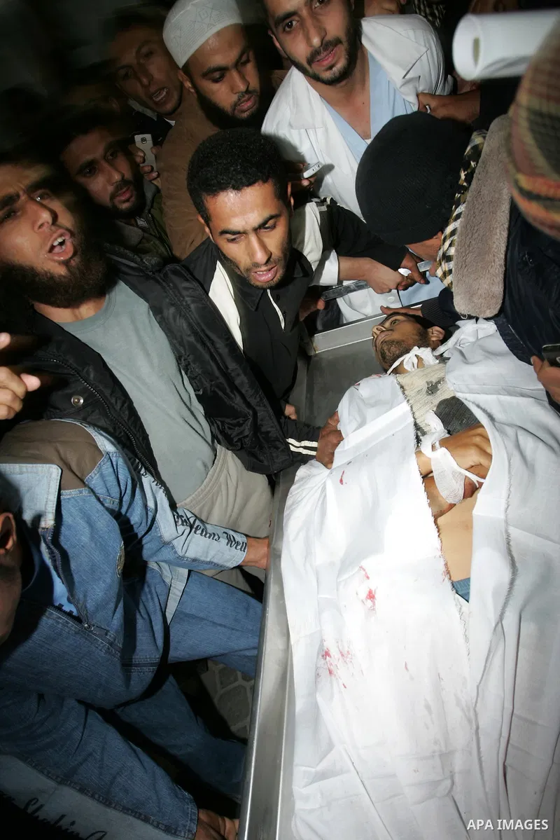 Palestinians gather as the body of Abdullah Mohana, Islamic Jihad militant, is brought to the morgue of the Nasser hospital in Khan Younis, southern Gaza Strip, Saturday, Nov. 5, 2011. A Palestinian official said that on...