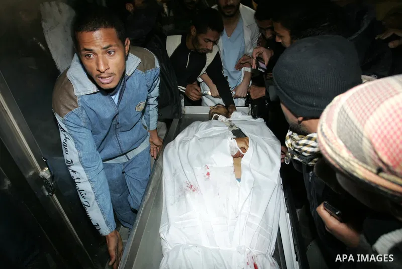 Palestinians gather as the body of Abdullah Mohana, Islamic Jihad militant, is brought to the morgue of the Nasser hospital in Khan Younis, southern Gaza Strip, Saturday, Nov. 5, 2011. A Palestinian official said that on...