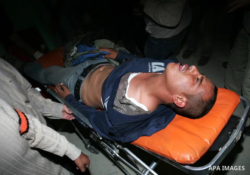 A wounded Palestinian youth is wheeled into a hospital in Khan Younis, southern Gaza Strip, Saturday, Nov. 5, 2011. A Palestinian official said that one of Islamic Jihads militants was killed and several others were woun...