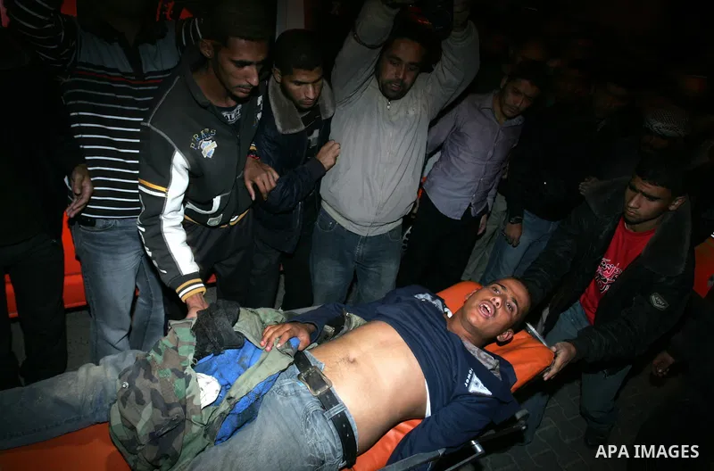 A wounded Palestinian youth is wheeled into a hospital in Khan Younis, southern Gaza Strip, Saturday, Nov. 5, 2011. A Palestinian official said that one of Islamic Jihads militants was killed and several others were woun...