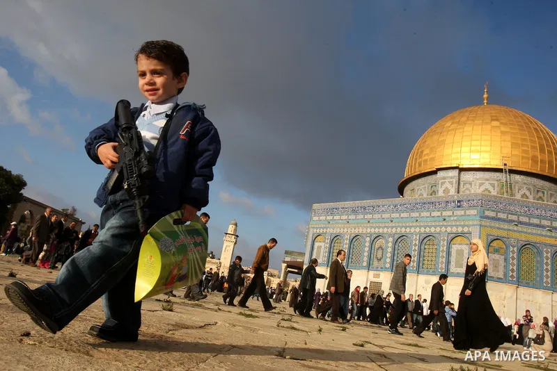Palestinians walk in front of the Dome of the Rock on the compound known to Muslims as al-Haram al-Sharif, and to Jews as Temple Mount, in Jerusalem's Old city, on the first day of Eid al-Adha November 6, 2011. Muslims a...