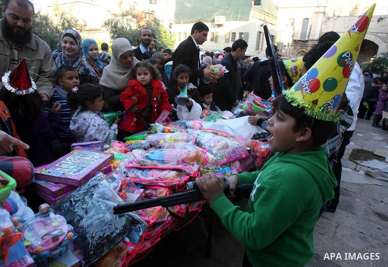 A Palestinian vendor sells toys outside the compound known to Muslims as al-Haram al-Sharif, and to Jews as Temple Mount, in Jerusalem's Old city, on the first day of Eid al-Adha November 6, 2011. Muslims around the worl...