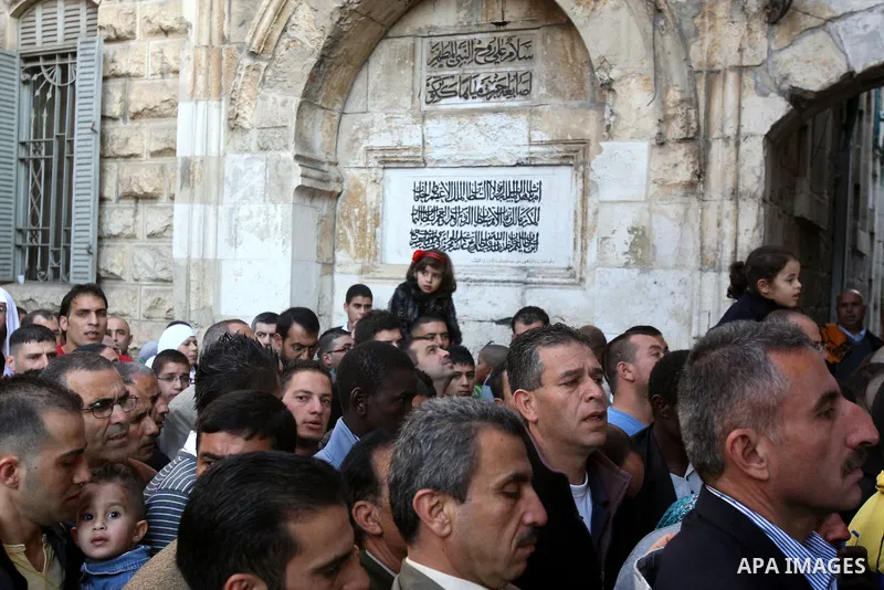 Palestinian men attend Friday prayers in front of the Al-Aqsa mosque on the compound known to Muslims as al-Haram al-Sharif, and to Jews as Temple Mount, in Jerusalem's Old city, on the first day of Eid al-Adha November...