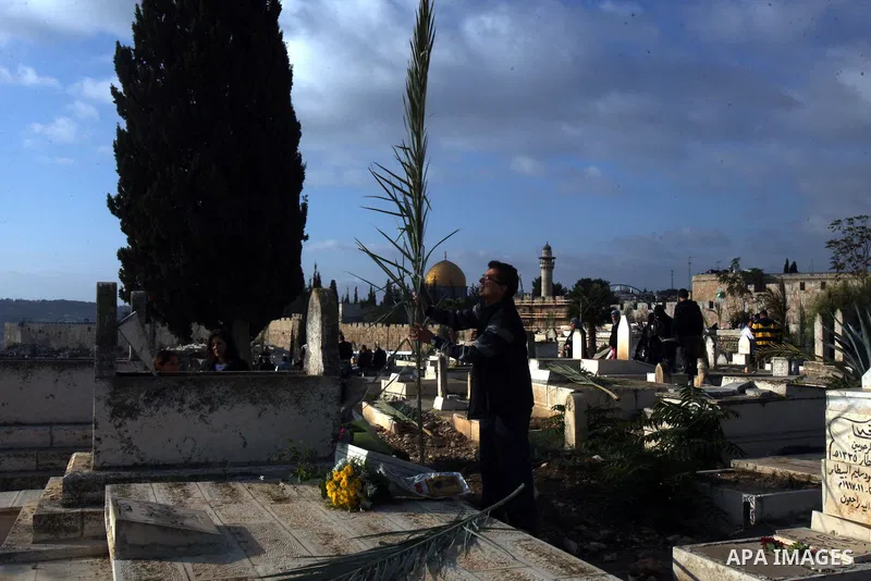 Palestinians visit the graves at a Muslim cemetery just outside Jerusalem's Old city on the first day of Eid al-Adha November 6, 2011. Muslims around the world celebrate Eid al-Adha to mark the end of the Hajj. The Dome...
