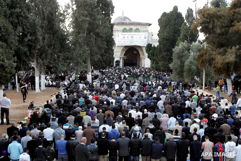 Palestinian men attend Friday prayers in front of the Al-Aqsa mosque on the compound known to Muslims as al-Haram al-Sharif, and to Jews as Temple Mount, in Jerusalem's Old city, on the first day of Eid al-Adha November...