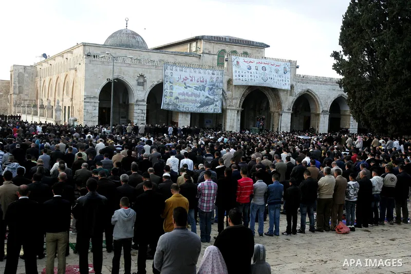 Palestinian men attend Friday prayers in front of the Al-Aqsa mosque on the compound known to Muslims as al-Haram al-Sharif, and to Jews as Temple Mount, in Jerusalem's Old city, on the first day of Eid al-Adha November...