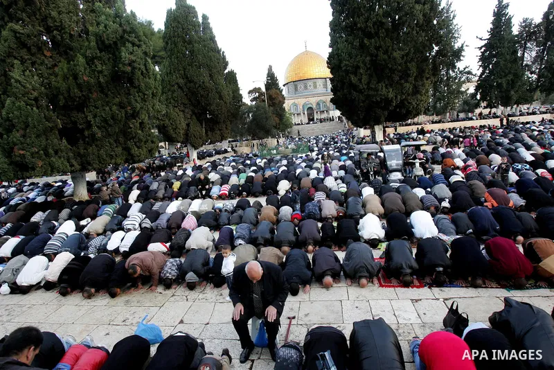 Palestinian men attend Friday prayers in front of the Dome of the Rock on the compound known to Muslims as al-Haram al-Sharif, and to Jews as Temple Mount, in Jerusalem's Old city, on the first day of Eid al-Adha Novembe...