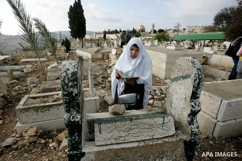 Palestinians visit the graves at a Muslim cemetery just outside Jerusalem's Old city on the first day of Eid al-Adha November 6, 2011. Muslims around the world celebrate Eid al-Adha to mark the end of the Hajj. The Dome...