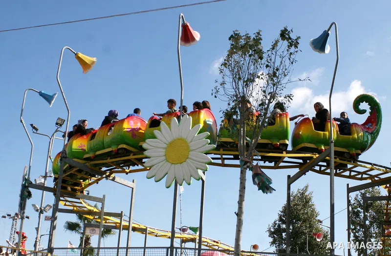 Palestinians enjoy riding at an amusement park during the second day of Eid al-Adha in the West Bank city of Ramallah on November 7, 2011. Muslims worldwide commemorate the Eid al-Adha, or the Feast of the Sacrifice, mar...