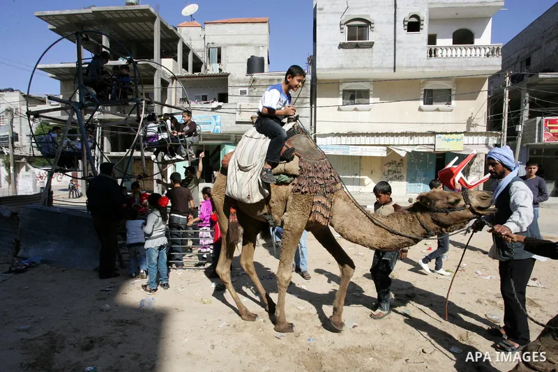 Palestinians enjoy riding during the second day of Eid al-Adha in the southern Gaza Strip town of Rafah on November 7, 2011. Muslims worldwide commemorate the Eid al-Adha, or the Feast of the Sacrifice, marking the end o...