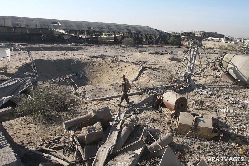 Palestinians remove rubble after an overnight Israeli air strike in Khan Younis in the southern Gaza Strip November 9, 2011. The Israeli military said it targeted a militant facility in response to rocket fire by Gaza mi...