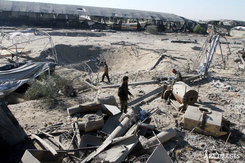 Palestinians remove rubble after an overnight Israeli air strike in Khan Younis in the southern Gaza Strip November 9, 2011. The Israeli military said it targeted a militant facility in response to rocket fire by Gaza mi...