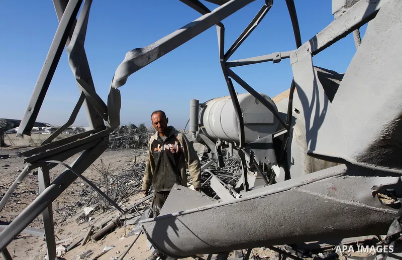Palestinians remove rubble after an overnight Israeli air strike in Khan Younis in the southern Gaza Strip November 9, 2011. The Israeli military said it targeted a militant facility in response to rocket fire by Gaza mi...