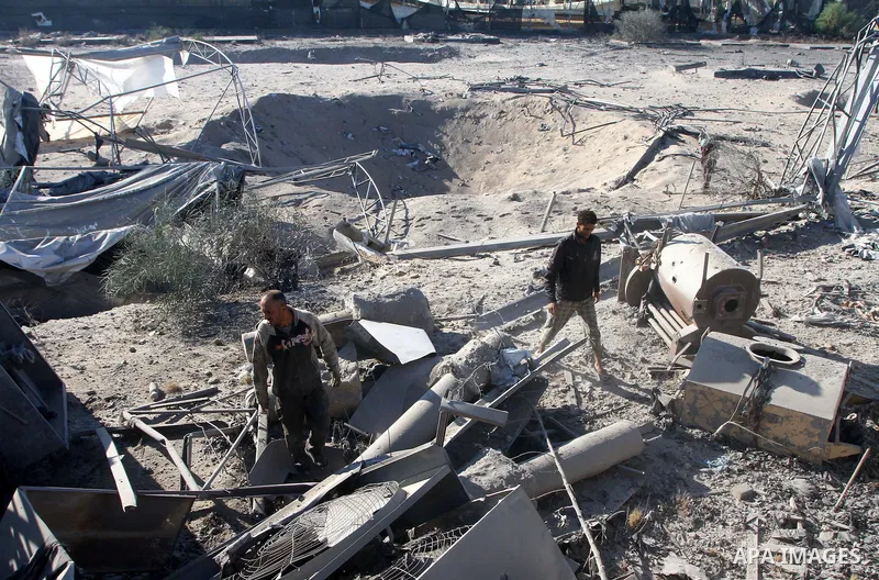 Palestinians remove rubble after an overnight Israeli air strike in Khan Younis in the southern Gaza Strip November 9, 2011. The Israeli military said it targeted a militant facility in response to rocket fire by Gaza mi...