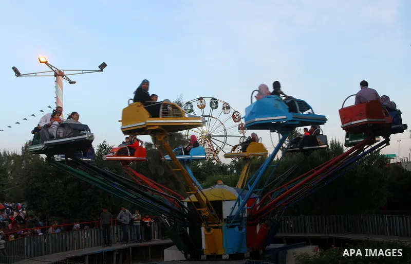 Palestinians enjoy a ride in an amusement park, during Eid al-Adha in Gaza City, Nov. 9, 2011. Muslims worldwide celebrate Eid al-Adha, or the Feast of the Sacrifice, with the sacrificial killing of livestock to commemor...