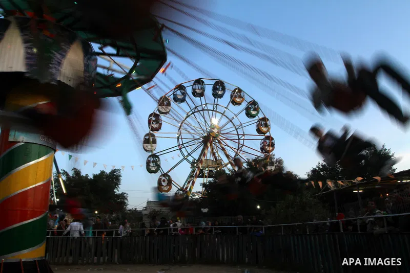 Palestinians enjoy a ride in an amusement park, during Eid al-Adha in Gaza City, Nov. 9, 2011. Muslims worldwide celebrate Eid al-Adha, or the Feast of the Sacrifice, with the sacrificial killing of livestock to commemor...
