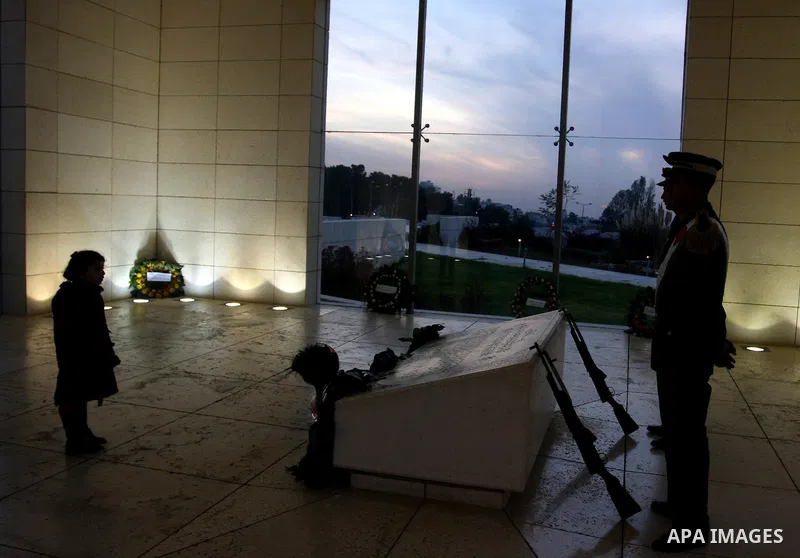 Palestinians lay flower wreathes and candles at the gravesite of late Palestinian leader Yasser Arafat on the seventh anniversary of his death in the West Bank city of Ramallah on November 11, 2011, as Palestinians gathe...