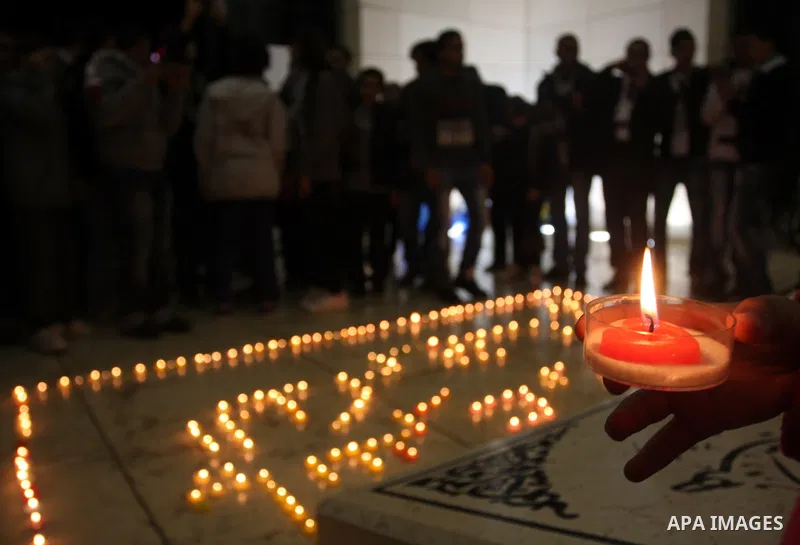Palestinians lay flower wreathes and candles at the gravesite of late Palestinian leader Yasser Arafat on the seventh anniversary of his death in the West Bank city of Ramallah on November 11, 2011, as Palestinians gathe...