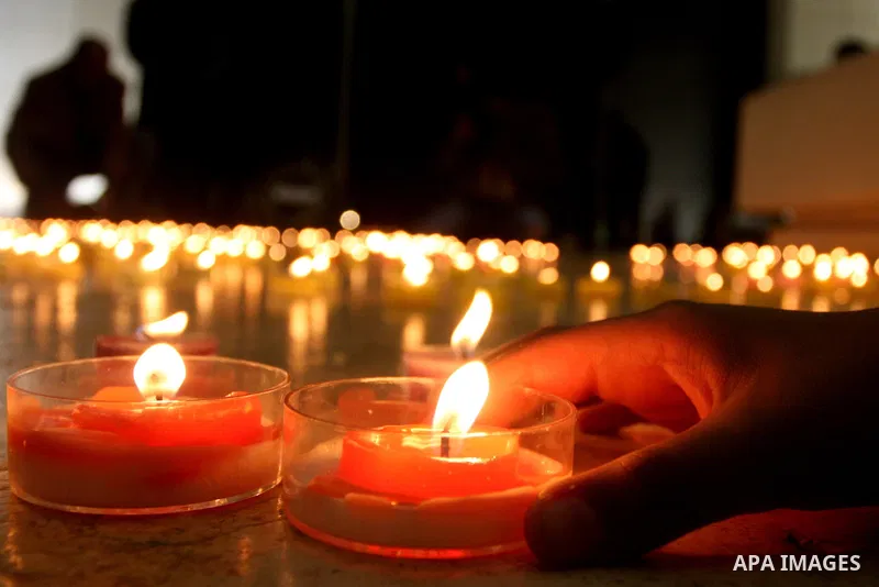 Palestinians lay flower wreathes and candles at the gravesite of late Palestinian leader Yasser Arafat on the seventh anniversary of his death in the West Bank city of Ramallah on November 11, 2011, as Palestinians gathe...