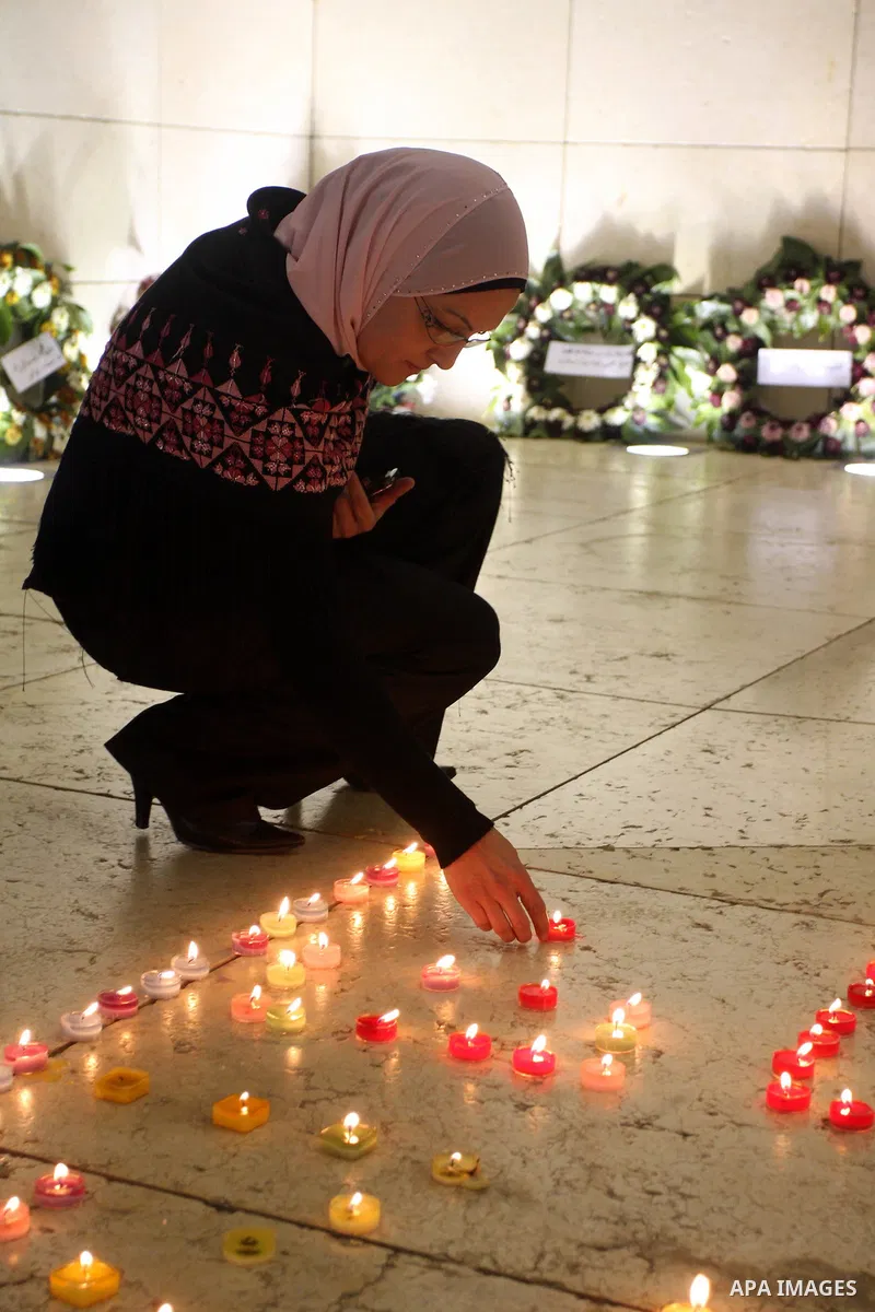 Palestinians lay flower wreathes and candles at the gravesite of late Palestinian leader Yasser Arafat on the seventh anniversary of his death in the West Bank city of Ramallah on November 11, 2011, as Palestinians gathe...
