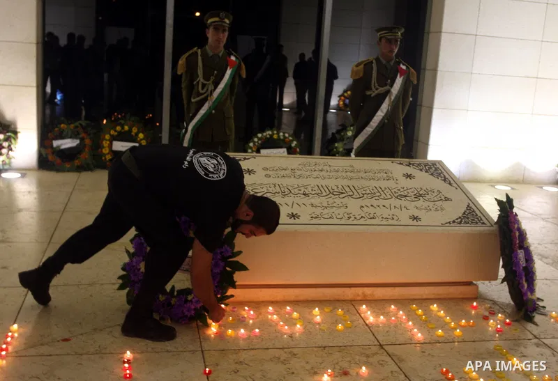 Palestinians lay flower wreathes and candles at the gravesite of late Palestinian leader Yasser Arafat on the seventh anniversary of his death in the West Bank city of Ramallah on November 11, 2011, as Palestinians gathe...