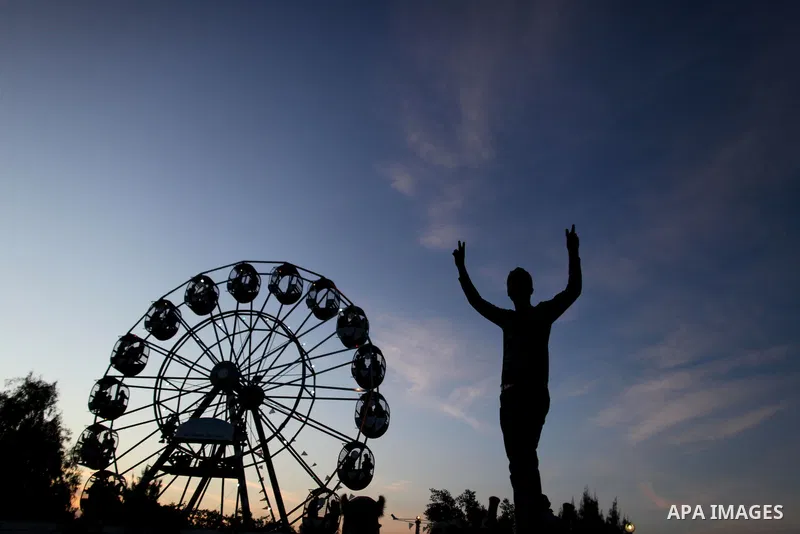 Palestinians enjoy a ride in an amusement park, during Eid al-Adha in Gaza City, Nov. 10, 2011. Muslims worldwide celebrate Eid al-Adha, or the Feast of the Sacrifice, with the sacrificial killing of livestock to commemo...