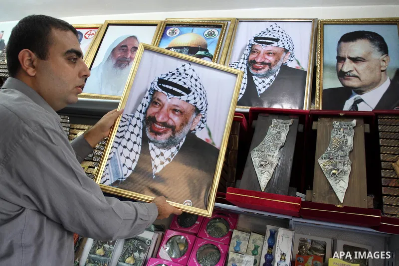 A Palestinian man holds a picture of late Palestinian leader Yasser Arafat in Gaza city, on 11 November 2011. Arafat, who spearheaded the Palestinian cause for some four decades, died on 11 November 2004 in a Paris hospi...