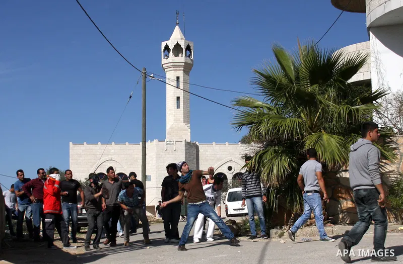 Palestinian protestors hurl stones toward Israeli forces during a weekly demonstration against Israeli-occupation in the northern West Bank village of Kfar Kadum, on November 11, 2011. The Palestinian leadership is unsur...