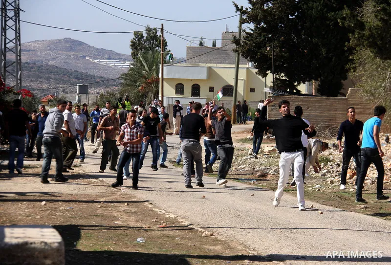 Palestinian protestors hurl stones toward Israeli forces during a weekly demonstration against Israeli-occupation in the northern West Bank village of Kfar Kadum, on November 11, 2011. The Palestinian leadership is unsur...