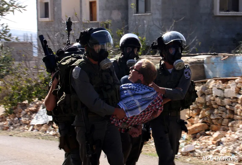 Israeli forces arrest a protestor during a weekly demonstration against Israeli-occupation in the northern West Bank village of Kfar Kadum, on November 11, 2011. The Palestinian leadership is unsure how to advance its bi...