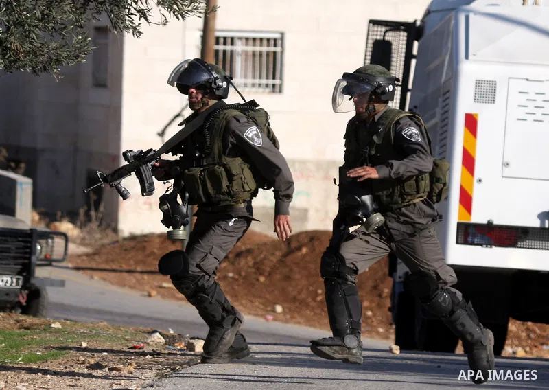 Israeli soldiers take positions during clashes between Israeli security forces and Palestinian demonstrators at a weekly protest in the West Bank village of Nabi Saleh, near Ramallah November 11, 2011.. Photo by Issam Ri...