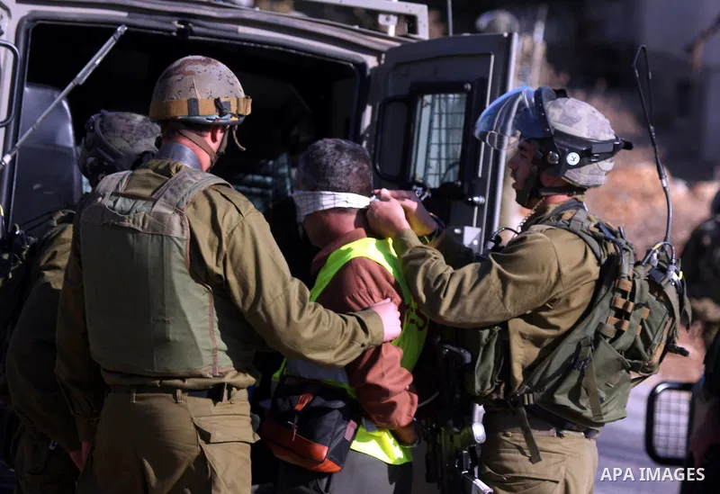 Israeli soldiers detain a Palestinian cameraman, Bilal Tamimi, during clashes between Israeli security forces and Palestinian demonstrators at a weekly protest in the West Bank village of Nabi Saleh, near Ramallah Novemb...