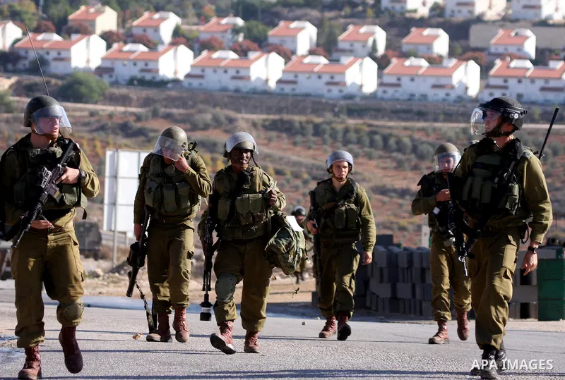 Israeli soldiers take positions during clashes between Israeli security forces and Palestinian demonstrators at a weekly protest in the West Bank village of Nabi Saleh, near Ramallah November 11, 2011.. Photo by Issam Ri...