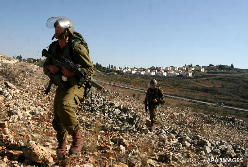 Israeli soldiers take positions during clashes between Israeli security forces and Palestinian demonstrators at a weekly protest in the West Bank village of Nabi Saleh, near Ramallah November 11, 2011.. Photo by Issam Ri...