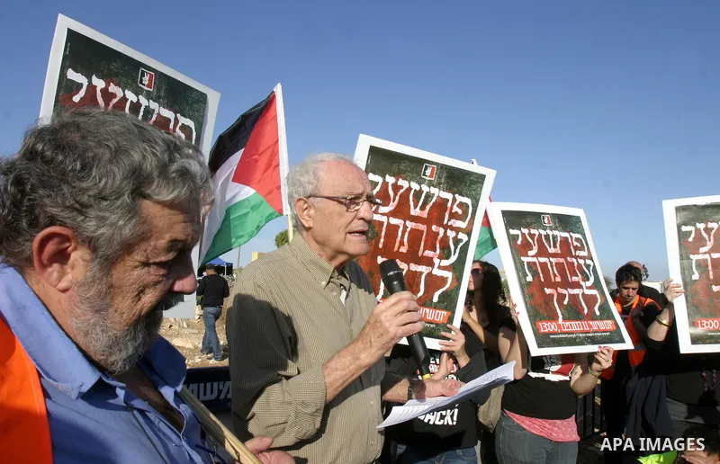 Israeli soldiers stand guard as Palestinian demonstrators take part in a protest in the mostly Arab Jerusalem neighbourhood of Enata on Nov.11,2011. Photo by Mahfouz Abu Turk