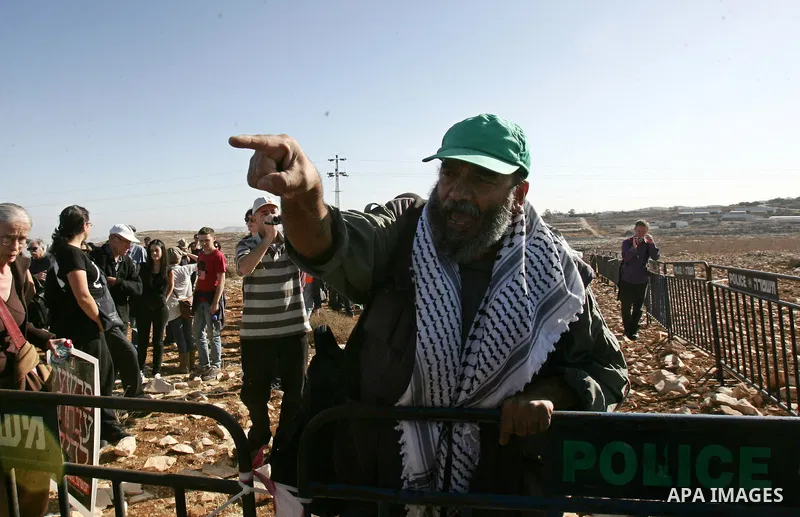 Israeli soldiers stand guard as Palestinian demonstrators take part in a protest in the mostly Arab Jerusalem neighbourhood of Enata on Nov.11,2011. Photo by Mahfouz Abu Turk