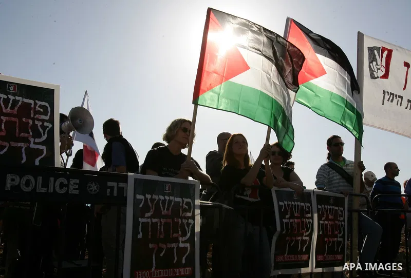 Israeli soldiers stand guard as Palestinian demonstrators take part in a protest in the mostly Arab Jerusalem neighbourhood of Enata on Nov.11,2011. Photo by Mahfouz Abu Turk