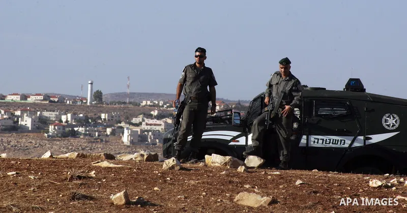 Israeli soldiers stand guard as Palestinian demonstrators take part in a protest in the mostly Arab Jerusalem neighbourhood of Enata on Nov.11,2011. Photo by Mahfouz Abu Turk